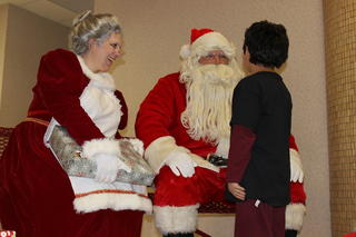 Mrs. Claus and Santa with kid