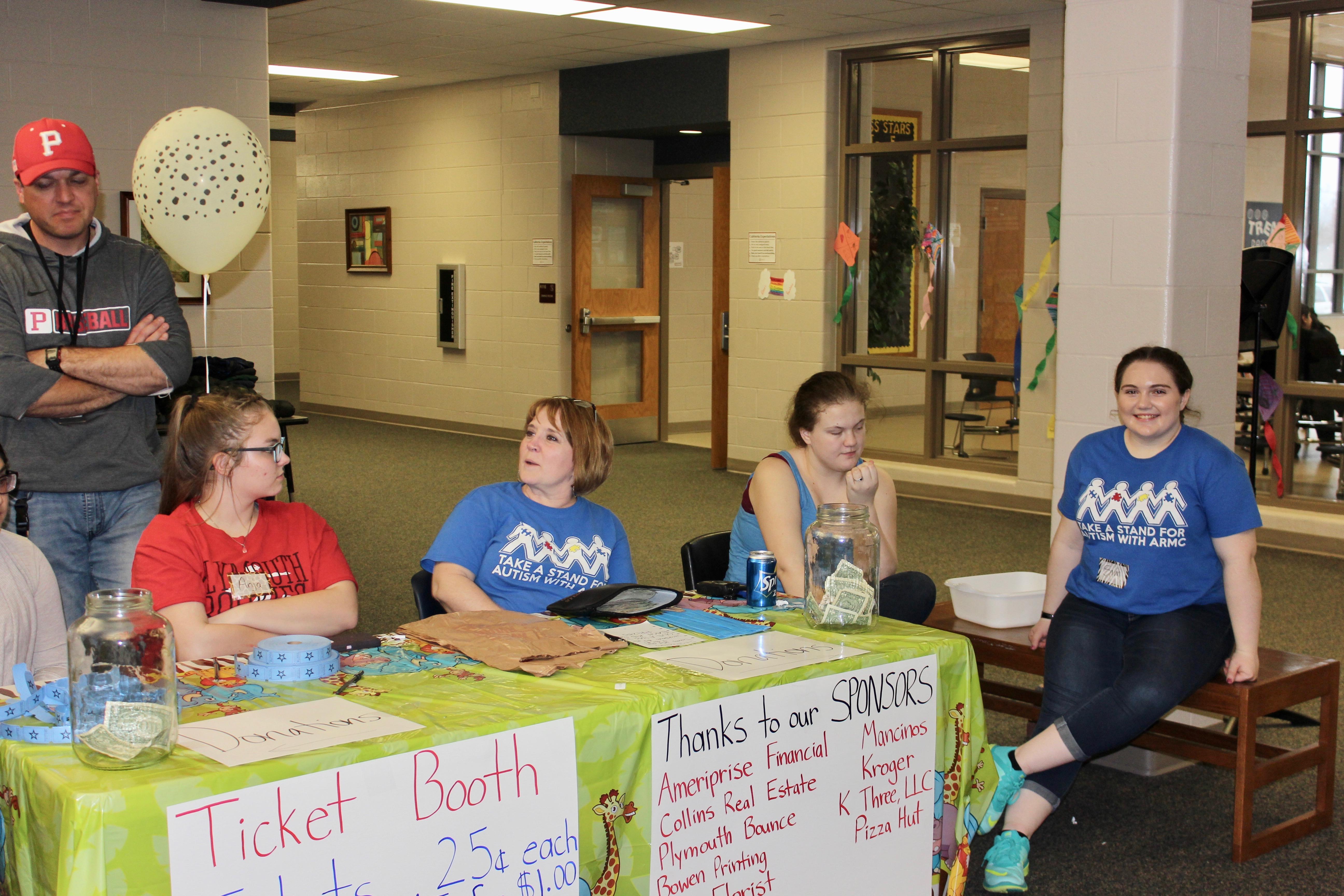 PHS students, Ryan Wolfe, Samantha and Teri Zechiel working welcome table.