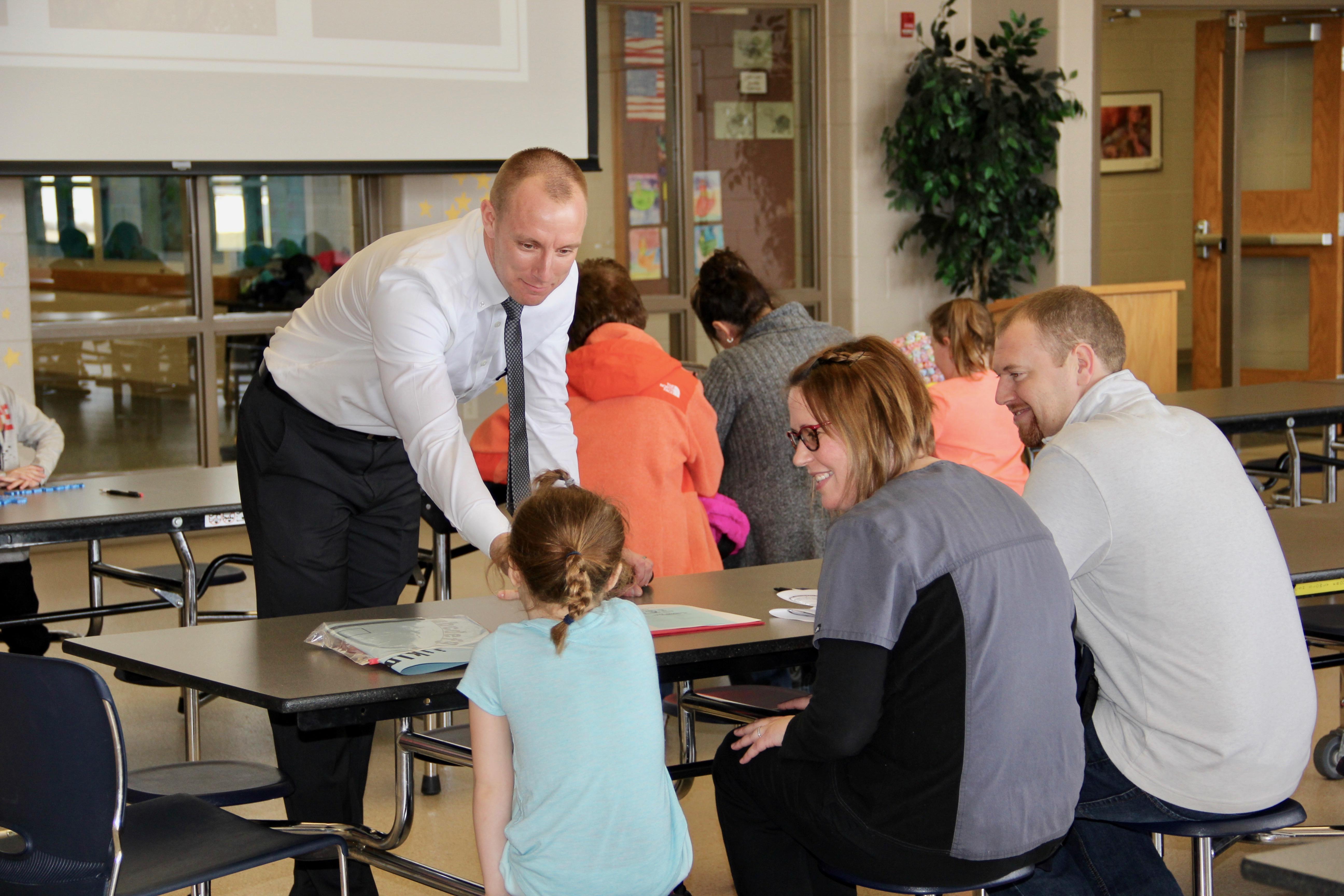 Menominee Elementary School Principal Steven Boyer talks to parents about how he and his staff can help incoming kindergarten children and parents prepare for the start of school.