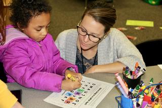 PCSC Director of Quality Programs Brooke Busse, meets with incoming kindergarten student Stacey Baker at Menominee during kindergarten roundup. 
