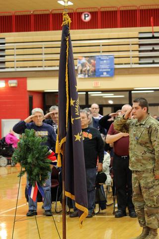 Staff Sergeant Diaz from the National Guard saluting flag and wreath