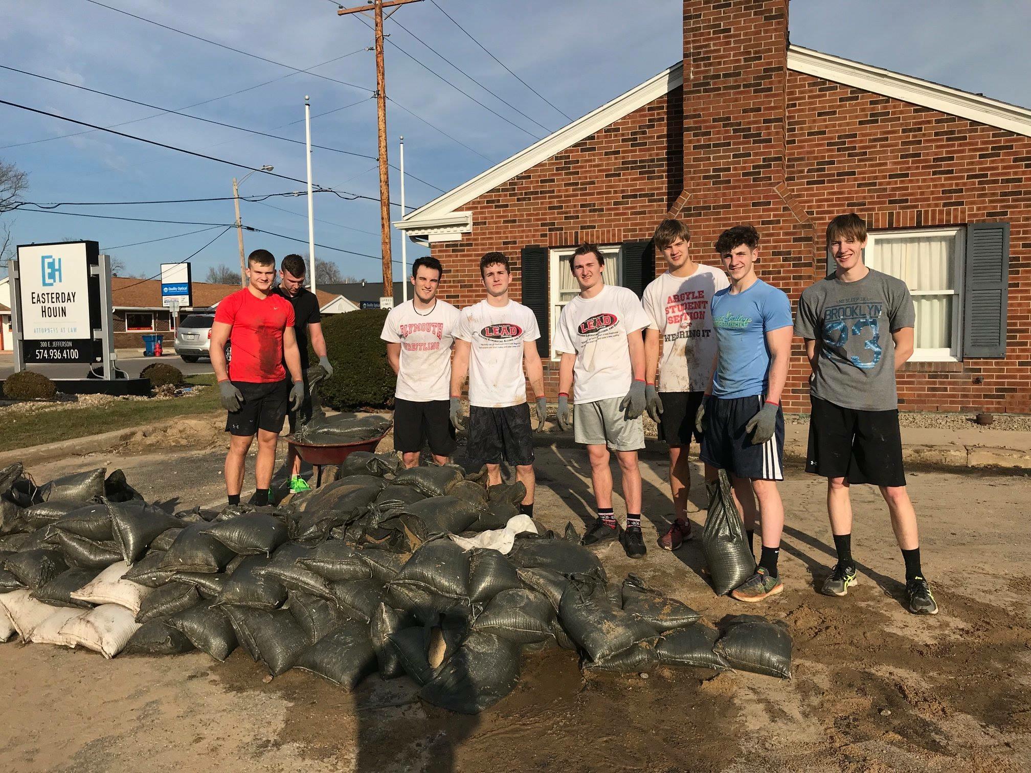 Some of the PHS track team helping move sandbags.