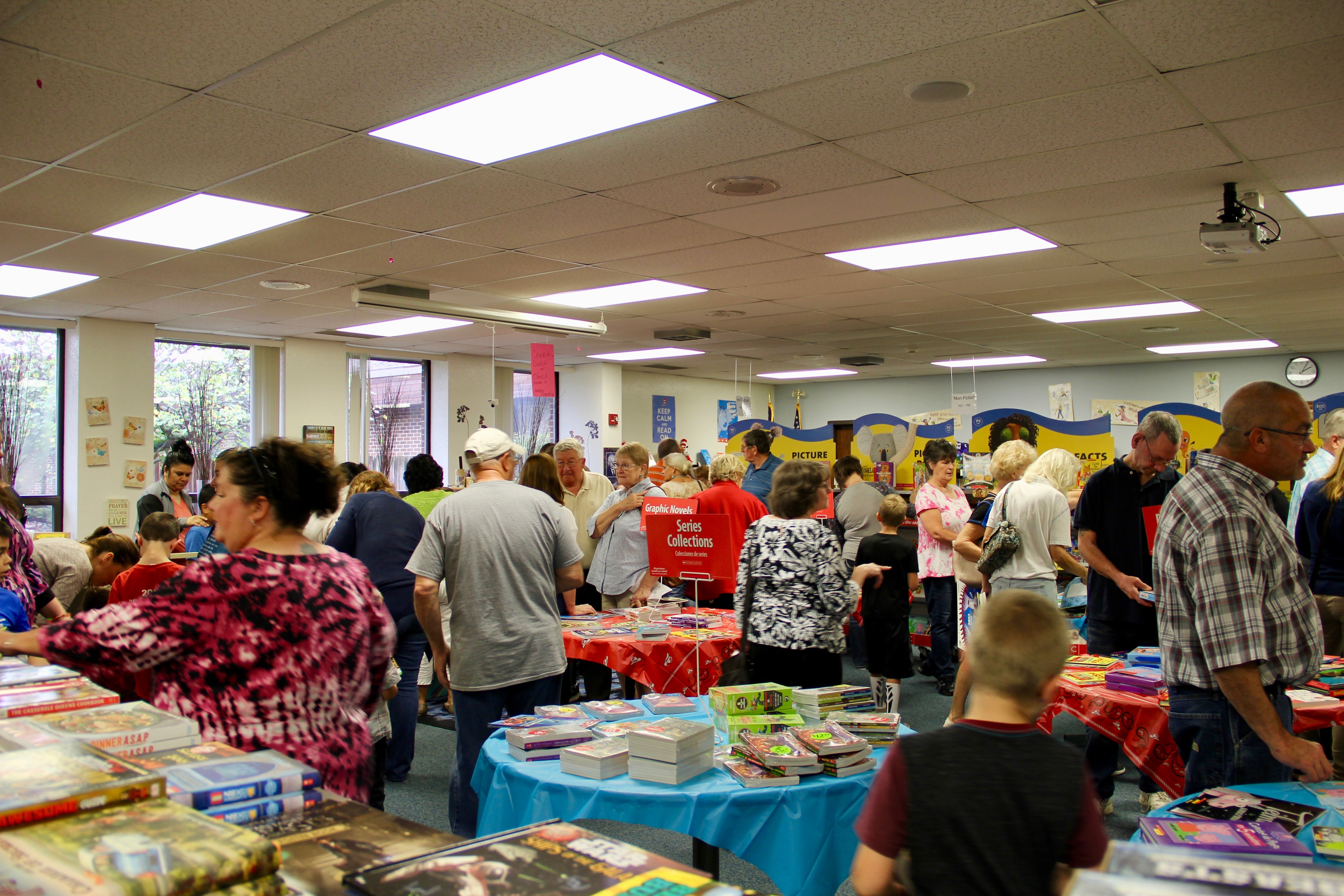 VIP guests and students shopping at the book fair that was hosted in the library.