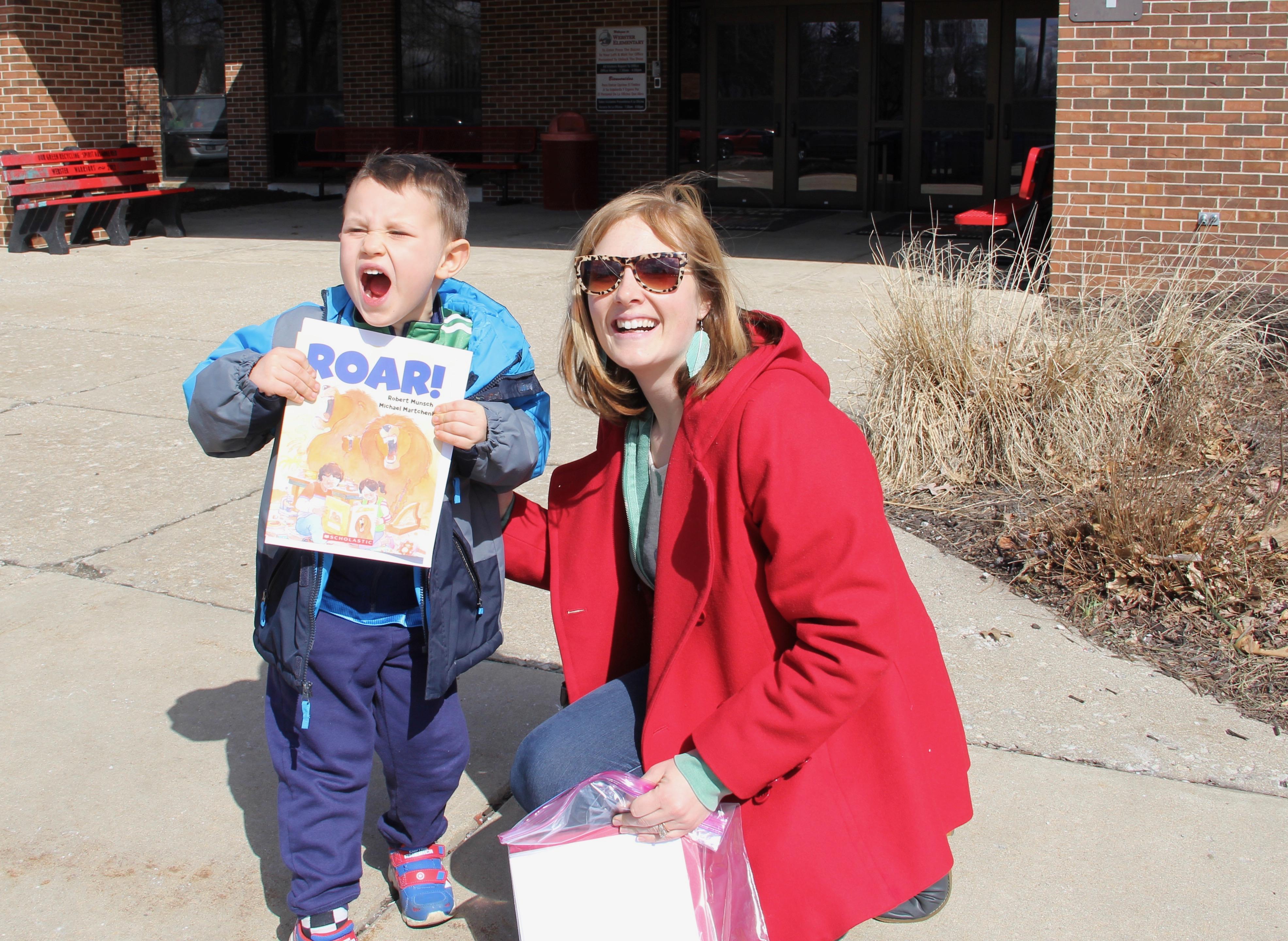 Eamonn Day loves lions and reading about them. He demonstrates the sound a lion makes as he and his mom, Haley, pause for a picture after leaving PCSC's Kindergarten Roundup at Webster on Thursday.