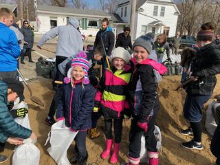 Students filling sandbags - Eloise Walters (Webster Kindergarten Student), Isabella Walters (Webster 4th Grade), and Olivia Warner (Webster 3rd Grade)