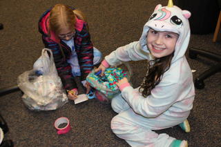 Two students with presents at Santa's Workshop