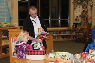 Parent and Menominee student with presents from Santa's Workshop.
