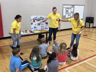 PHS students talking to Menominee students about health eating habits.