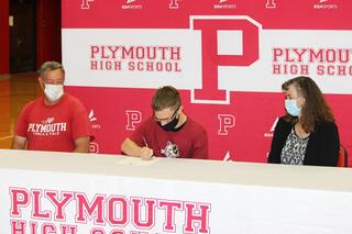 Nick Anders signing with parents