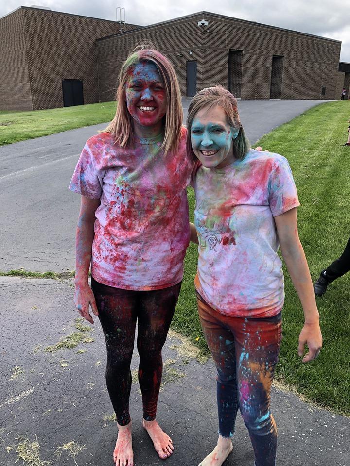 Teachers Mrs. Mentz and Mrs. Corbett with color run dye on them.