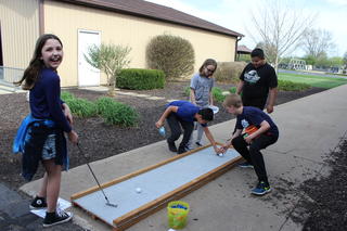 Webster students playing miniature golf.